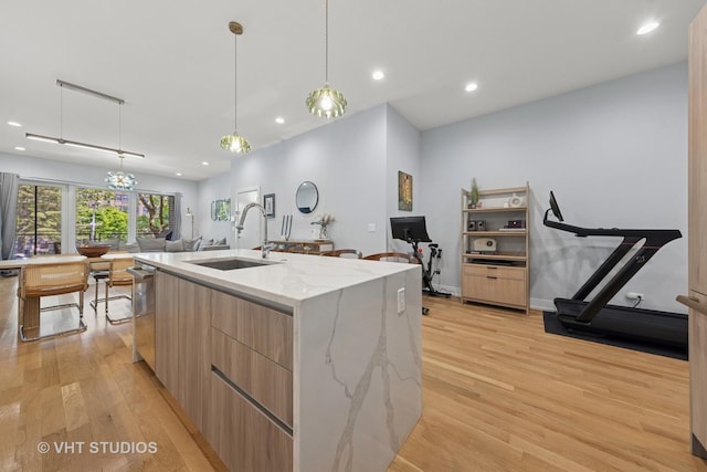 5236 N Kenmore Ave Unit 1N, Chicago, IL 60640 - kitchen with modern cabinets, light wood finished floors, recessed lighting, light brown cabinetry, and a kitchen island with sink