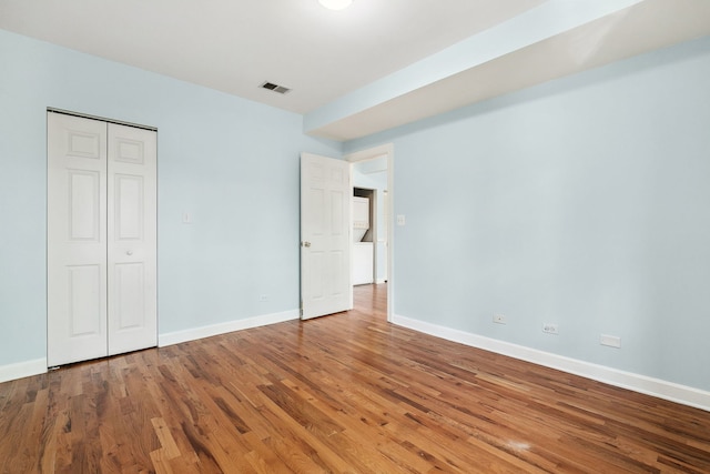 2554 W Rosemont Ave Unit 3, Chicago, IL 60659 - unfurnished bedroom with wood finished floors and a closet