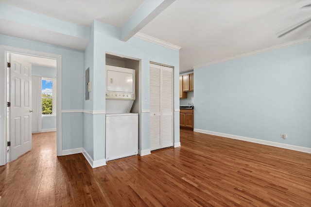 2554 W Rosemont Ave Unit 3, Chicago, IL 60659 - unfurnished bedroom featuring stacked washer / drying machine, wood finished floors, crown molding, and a closet