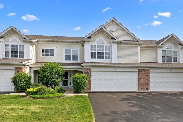 905 Huntington Dr, Elk Grove Village, IL 60007 - multi unit property with driveway, an attached garage, brick siding, roof with shingles, and a front yard