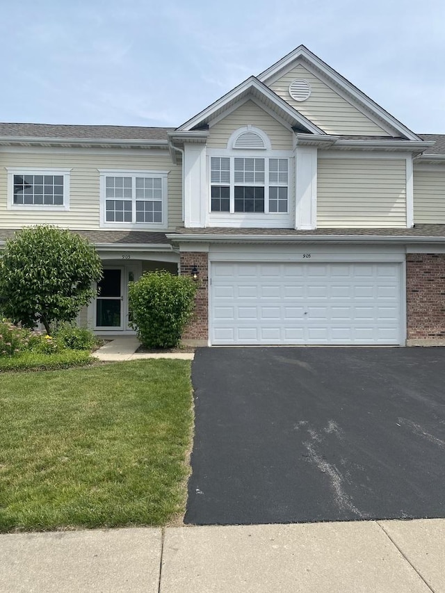 905 Huntington Dr, Elk Grove Village, IL 60007 - view of front of home featuring brick siding, a garage, and driveway