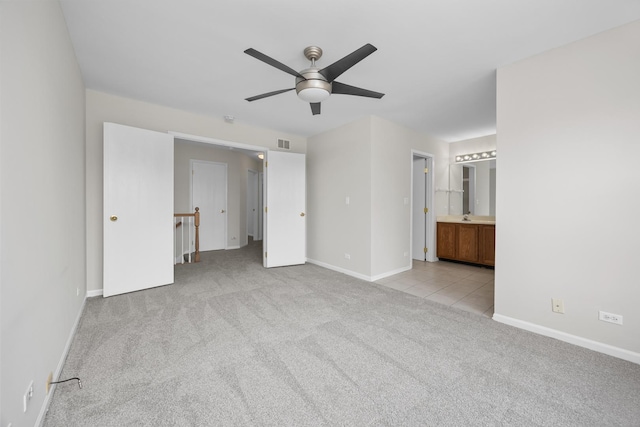 905 Huntington Dr, Elk Grove Village, IL 60007 - unfurnished bedroom with light carpet, ensuite bath, and a ceiling fan