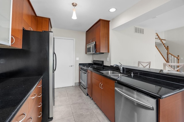 905 Huntington Dr, Elk Grove Village, IL 60007 - kitchen featuring appliances with stainless steel finishes, brown cabinets, light tile patterned floors, and a peninsula