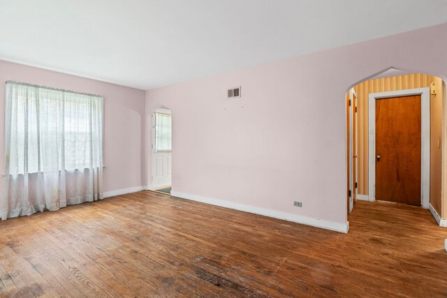 418 S Vail Ave, Arlington Heights, IL 60005 - empty room with arched walkways and wood finished floors