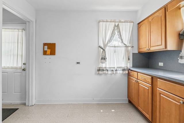 418 S Vail Ave, Arlington Heights, IL 60005 - kitchen with light floors, brown cabinetry, light countertops, and backsplash