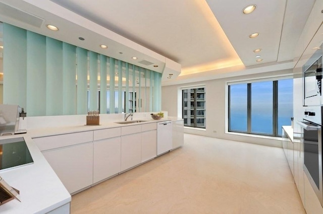 950 N Michigan Ave Unit 4003, Chicago, IL 60611 - kitchen with stainless steel appliances, recessed lighting, white cabinets, light countertops, and a raised ceiling