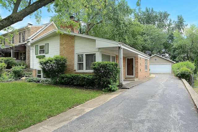 333 Elm St, Glen Ellyn, IL 60137 - view of front of home featuring brick siding, a garage, an outbuilding, a chimney, and a front yard