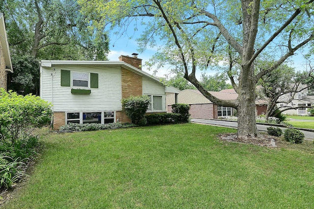333 Elm St, Glen Ellyn, IL 60137 - back of property with a chimney, brick siding, and a lawn