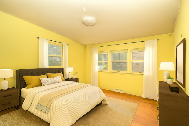 333 Elm St, Glen Ellyn, IL 60137 - bedroom featuring a baseboard heating unit, wood finished floors, and lofted ceiling