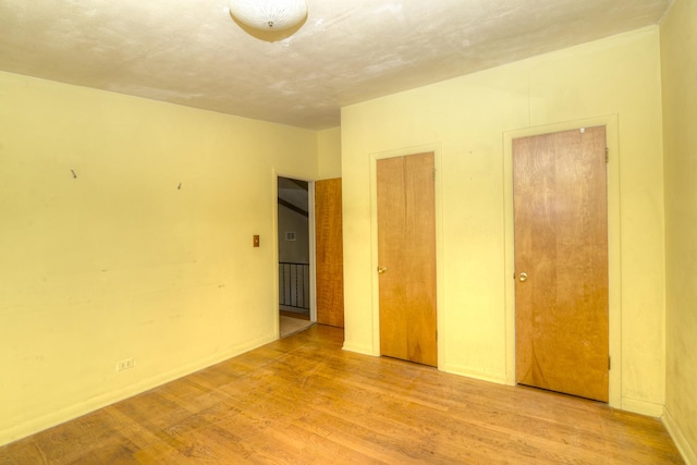 333 Elm St, Glen Ellyn, IL 60137 - unfurnished bedroom with wood finished floors and multiple closets
