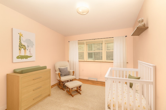 333 Elm St, Glen Ellyn, IL 60137 - bedroom with a nursery area, baseboard heating, wood finished floors, and vaulted ceiling