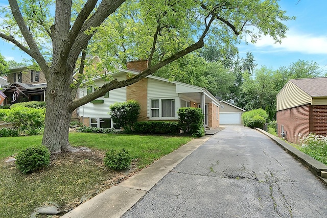 333 Elm St, Glen Ellyn, IL 60137 - view of home's exterior with a chimney, a detached garage, a lawn, an outdoor structure, and brick siding