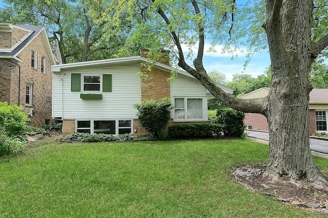 333 Elm St, Glen Ellyn, IL 60137 - view of front facade with a front yard, a chimney, and brick siding