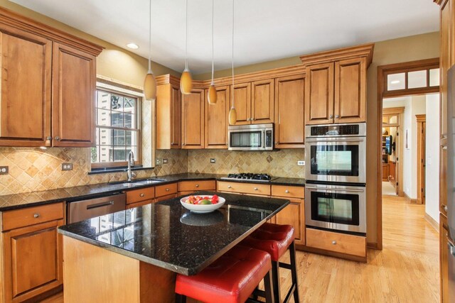 1560 Fairway Cir, Geneva, IL 60134 - kitchen featuring stainless steel appliances, light wood-type flooring, brown cabinets, a breakfast bar, and recessed lighting
