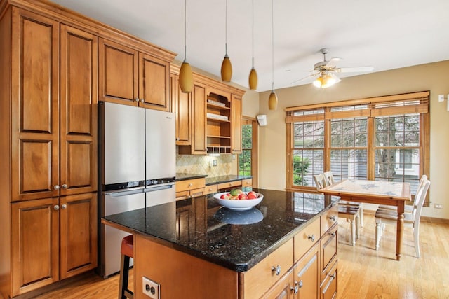 1560 Fairway Cir, Geneva, IL 60134 - kitchen with freestanding refrigerator, light wood-type flooring, a ceiling fan, backsplash, and brown cabinetry