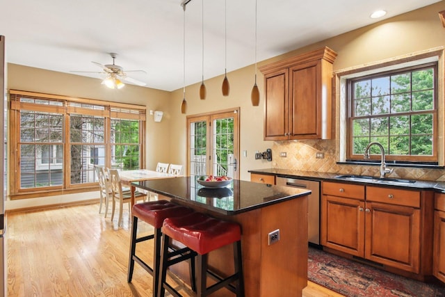 1560 Fairway Cir, Geneva, IL 60134 - kitchen featuring dishwasher, backsplash, brown cabinets, and light wood-style flooring