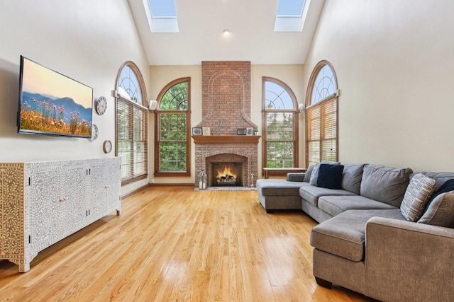 1560 Fairway Cir, Geneva, IL 60134 - living room with high vaulted ceiling, a skylight, wood finished floors, and a brick fireplace