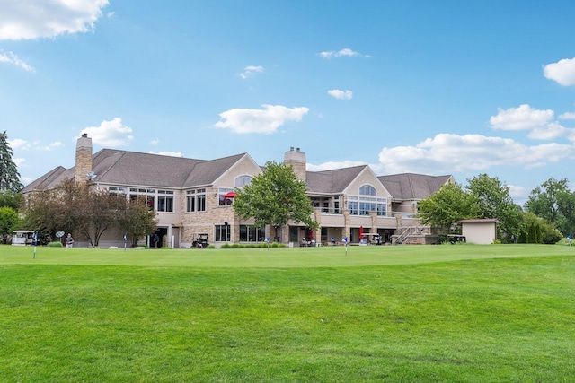 1560 Fairway Cir, Geneva, IL 60134 - back of property featuring a chimney, a yard, and stone siding
