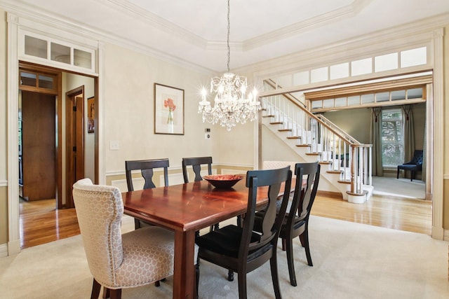 1560 Fairway Cir, Geneva, IL 60134 - dining room featuring stairs, crown molding, light colored carpet, a tray ceiling, and light wood-style floors
