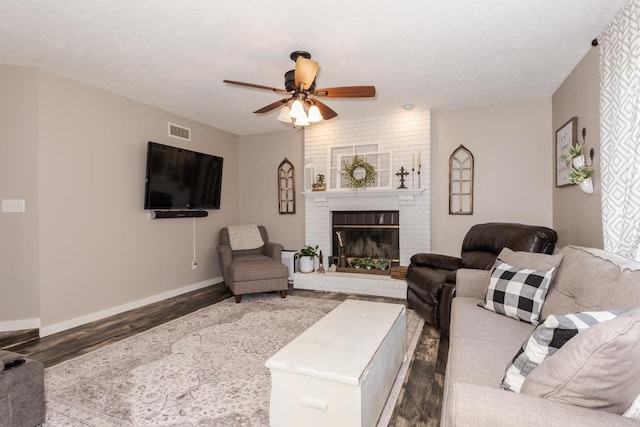 1608 Surrey St, Normal, IL 61761 - living room featuring dark wood-style floors, ceiling fan, and a fireplace