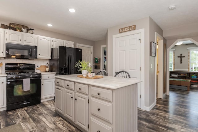 1608 Surrey St, Normal, IL 61761 - kitchen featuring black appliances, light countertops, white cabinets, tasteful backsplash, and recessed lighting