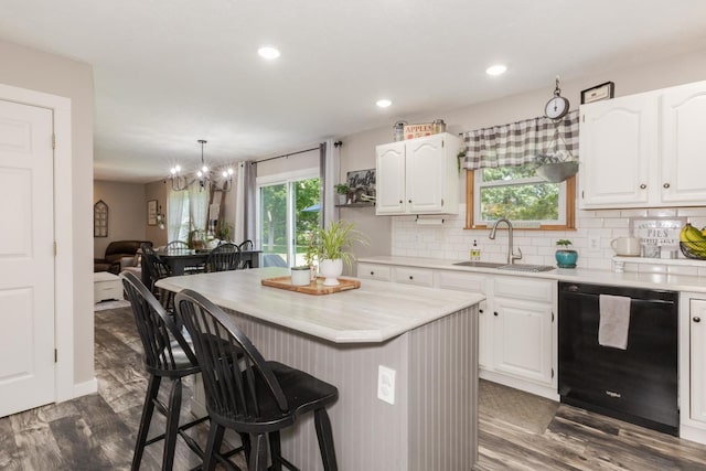 1608 Surrey St, Normal, IL 61761 - kitchen with dishwasher, a kitchen bar, light countertops, white cabinetry, and recessed lighting