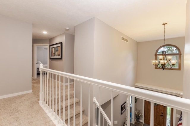 1608 Surrey St, Normal, IL 61761 - hallway featuring carpet flooring, a chandelier, an upstairs landing, and recessed lighting