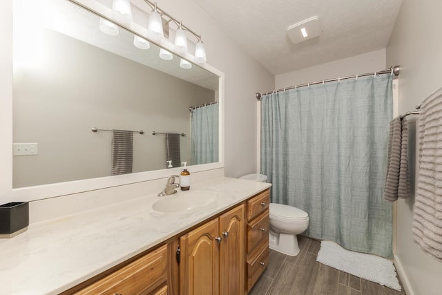 1608 Surrey St, Normal, IL 61761 - full bath featuring vanity, wood finished floors, and a textured ceiling