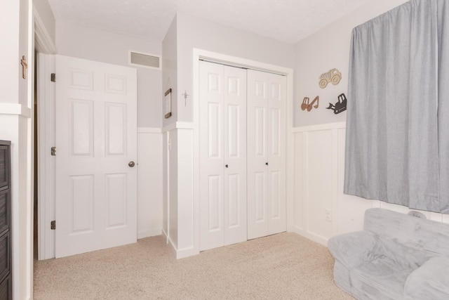 1608 Surrey St, Normal, IL 61761 - unfurnished room featuring wainscoting, carpet, and a decorative wall