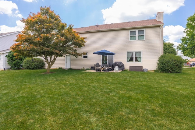 1608 Surrey St, Normal, IL 61761 - rear view of property with a chimney, a lawn, and a patio area