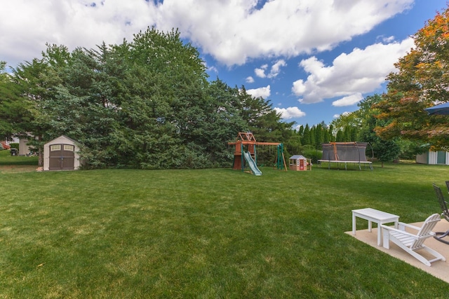 1608 Surrey St, Normal, IL 61761 - view of green lawn featuring a trampoline, a shed, and a playground