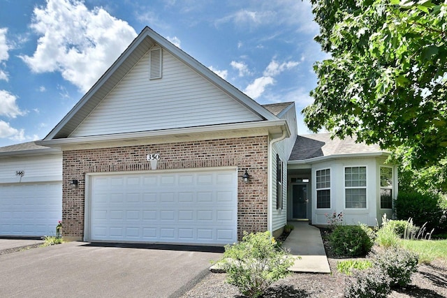 350 Woodhill Dr, Carol Stream, IL 60188 - view of front of home with an attached garage, driveway, and brick siding