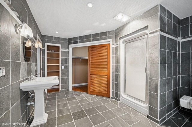 13 Chipping Campden Dr, South Barrington, IL 60010 - full bathroom featuring tile walls, tile patterned flooring, a shower stall, a walk in closet, and recessed lighting