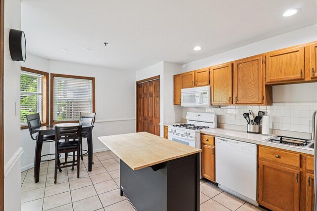 35 Terrace Ln Unit C, Lake Zurich, IL 60047 - kitchen featuring white appliances, tasteful backsplash, light tile patterned floors, wooden counters, and recessed lighting