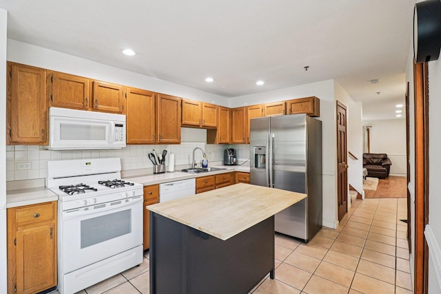 35 Terrace Ln Unit C, Lake Zurich, IL 60047 - kitchen with white appliances, light tile patterned flooring, decorative backsplash, recessed lighting, and brown cabinetry