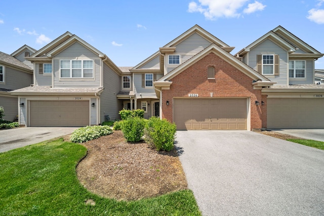 2026 Juniper Ct, Glendale Heights, IL 60139 - townhome / multi-family property with driveway, brick siding, and a garage