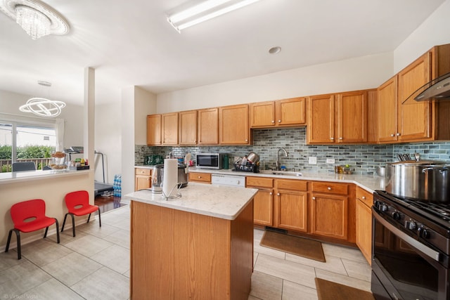 2026 Juniper Ct, Glendale Heights, IL 60139 - kitchen with stainless steel appliances, tasteful backsplash, a kitchen island, light tile patterned flooring, and a chandelier