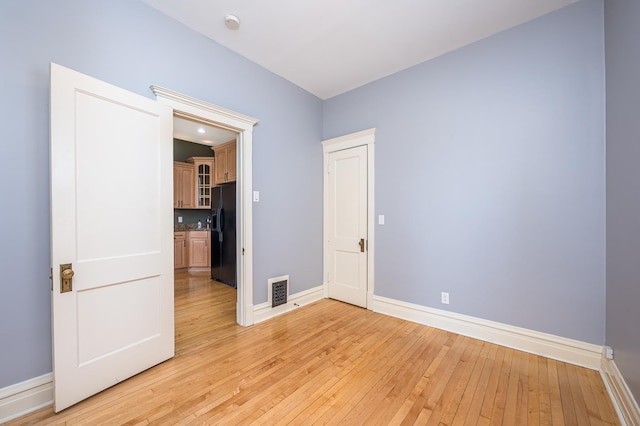 2115 N Sawyer Ave, Chicago, IL 60647 - unfurnished room with baseboards and light wood-style floors
