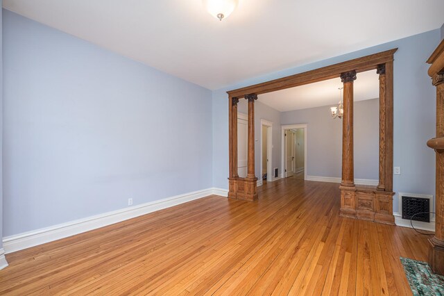 2115 N Sawyer Ave, Chicago, IL 60647 - unfurnished room with light wood finished floors and a chandelier