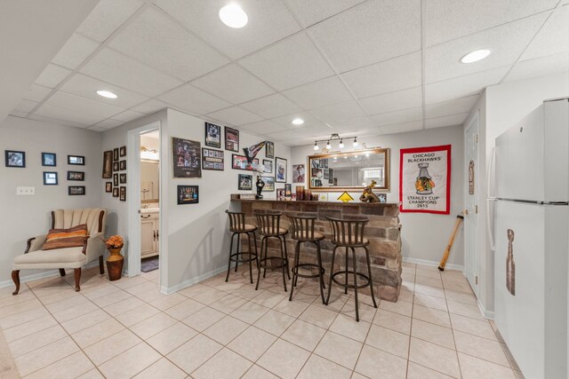 15431 Sulky Dr, Homer Glen, IL 60491 - indoor dry bar with freestanding refrigerator, a drop ceiling, light tile patterned floors, and recessed lighting