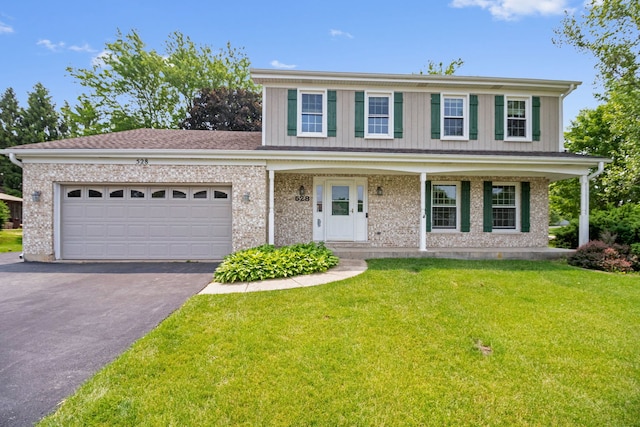 528 Carlson Ct, Batavia, IL 60510 - view of front of home with driveway, a garage, a front lawn, board and batten siding, and brick siding