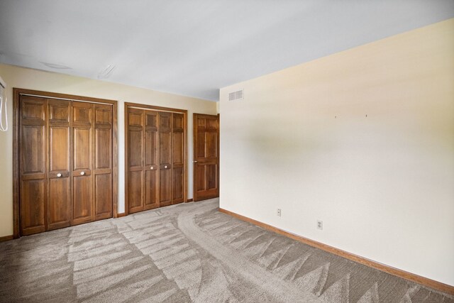 528 Carlson Ct, Batavia, IL 60510 - unfurnished bedroom with two closets and carpet flooring
