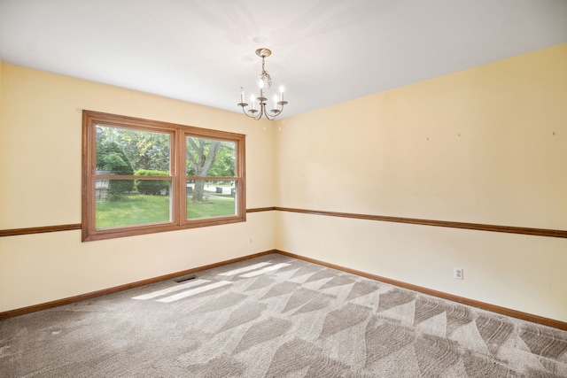 528 Carlson Ct, Batavia, IL 60510 - carpeted spare room with a chandelier and baseboards