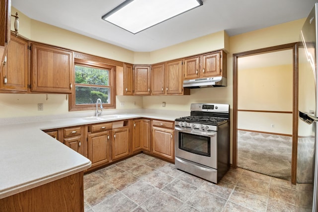 528 Carlson Ct, Batavia, IL 60510 - kitchen featuring stainless steel gas stove, under cabinet range hood, light countertops, refrigerator, and light stone finish floors