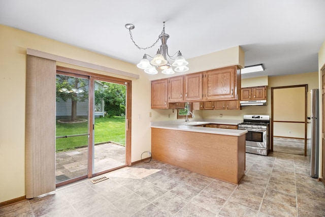 528 Carlson Ct, Batavia, IL 60510 - kitchen with gas range, a chandelier, a peninsula, light countertops, and freestanding refrigerator