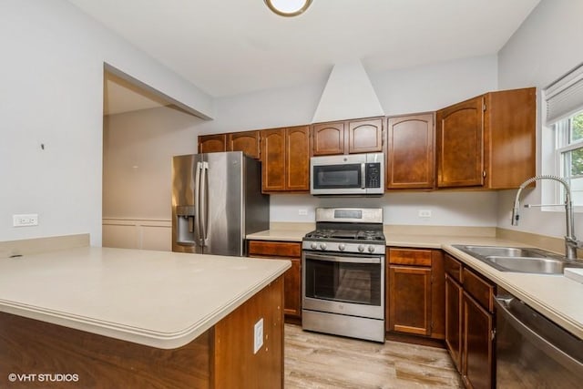 2733 Kendall Xing, Johnsburg, IL 60051 - kitchen with appliances with stainless steel finishes, light countertops, a peninsula, and light wood-style flooring