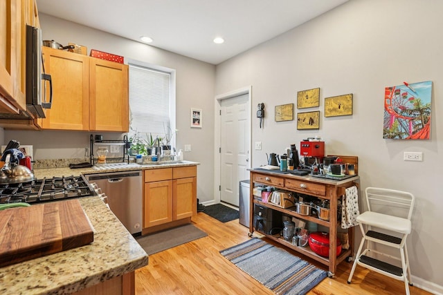 1639 W Farwell Ave Unit 1, Chicago, IL 60626 - kitchen with stainless steel dishwasher, light wood-type flooring, recessed lighting, and light stone counters