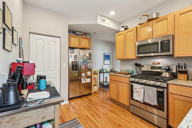1639 W Farwell Ave Unit 1, Chicago, IL 60626 - kitchen featuring stainless steel appliances, light wood finished floors, recessed lighting, light brown cabinetry, and light stone counters