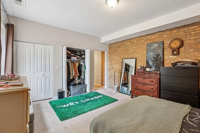 1639 W Farwell Ave Unit 1, Chicago, IL 60626 - bedroom featuring brick wall, light colored carpet, and multiple closets