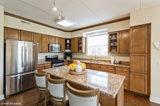 50 S Greeley St Unit 314, Palatine, IL 60067 - kitchen with stainless steel appliances, brown cabinets, crown molding, and a textured ceiling